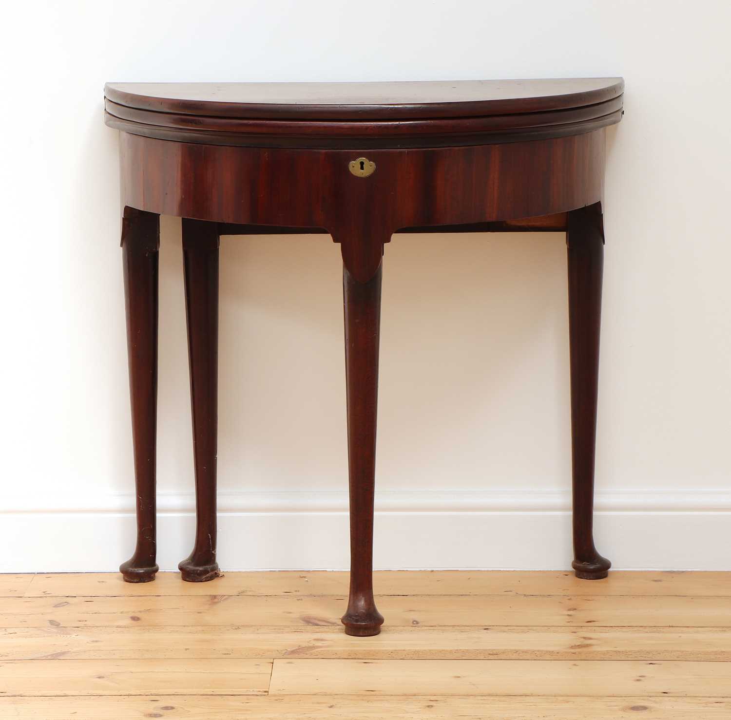 Lot 33 - A George II mahogany triple fold-over demilune side table