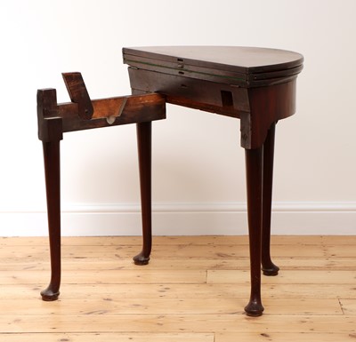 Lot 33 - A George II mahogany triple fold-over demilune side table