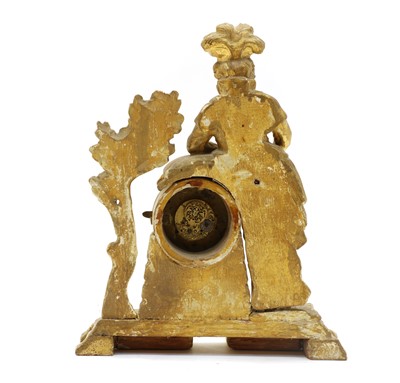 Lot 69 - An 18th century carved pine and gilt figural mantel clock