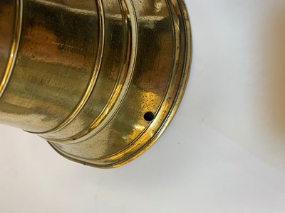 Lot 391 - A graduated set of four bell-shaped brass candlesticks