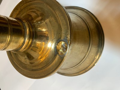 Lot 391 - A graduated set of four bell-shaped brass candlesticks