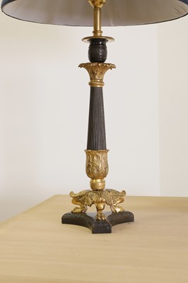 Lot 94 - A pair of French Empire-style patinated and gilt-bronze candlestick lamps