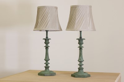 Lot 408 - A pair of verdigris candlestick lamps