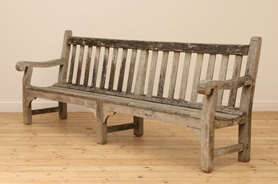 Lot 97 - A large weathered teak country house bench