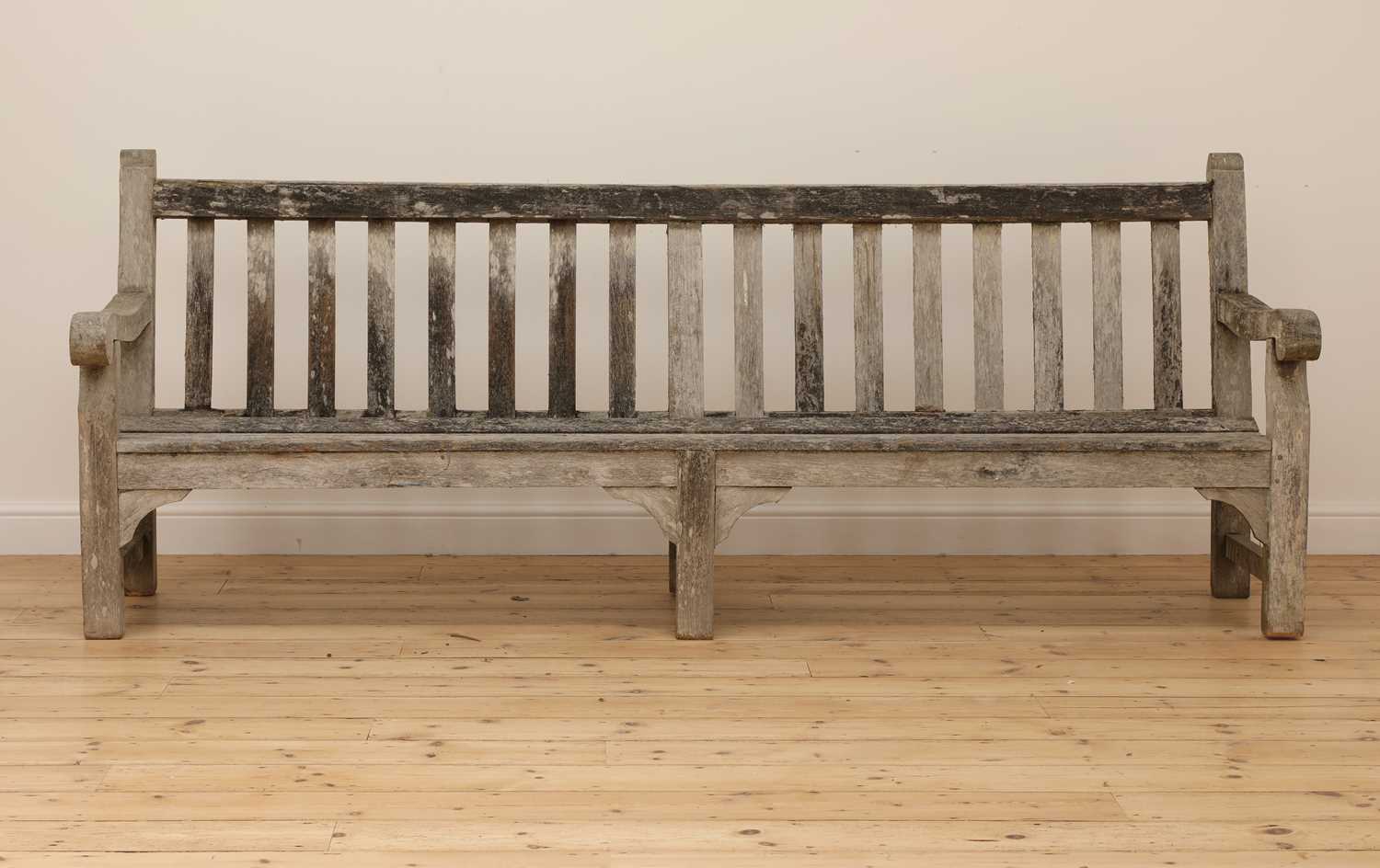 Lot 97 - A large weathered teak country house bench