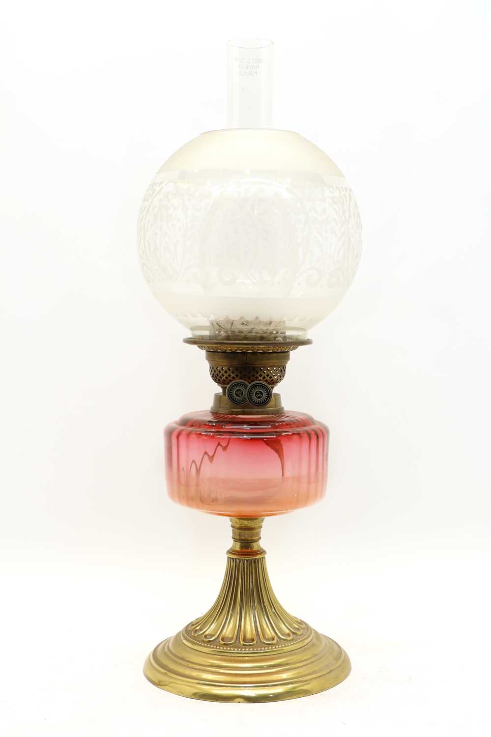Lot 256 - A Victorian brass and cranberry glass oil lamp