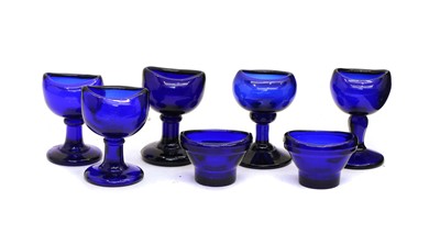 Lot 246 - Collection of clear and cobalt blue glass eye baths