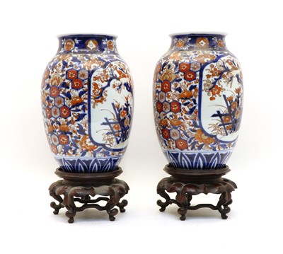 Lot 145 - A pair of Japanese Imari vases on stands