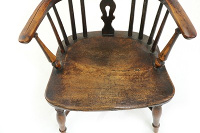 Lot 564 - An elm and yew child's Windsor chair