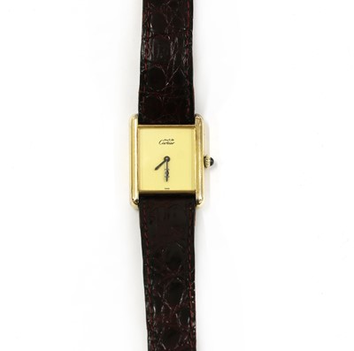 Lot 229 - A vermeil silver gilt Must de Cartier mechanical strap watch