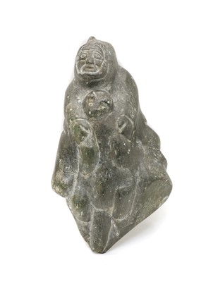 Lot 218 - An Eskimo hardstone carving of a man holding a seal