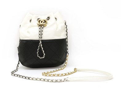 Lot 520 - A Chanel Gabrielle two-tone black and white leather bucket bag