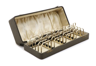 Lot 36 - A cased set of four Art Deco silver four division toast racks