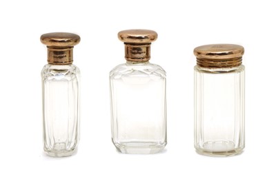 Lot 30 - A set of three 9ct gold mounted faceted glass toilet jars