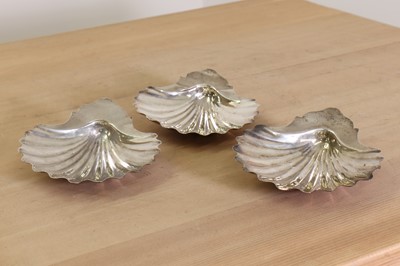 Lot 345 - A set of three George III silver butter dishes