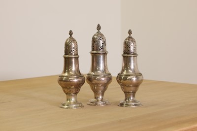 Lot 343 - A set of three George III silver condiment casters