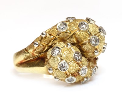 Lot 267 - An 18ct two colour gold diamond set bombé form crossover ring