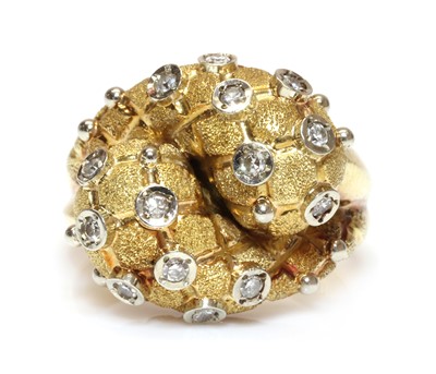 Lot 267 - An 18ct two colour gold diamond set bombé form crossover ring