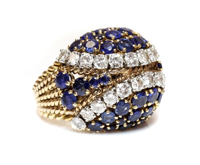 Lot 271 - An 18ct gold and platinum, diamond and sapphire bombé ring, c.1950