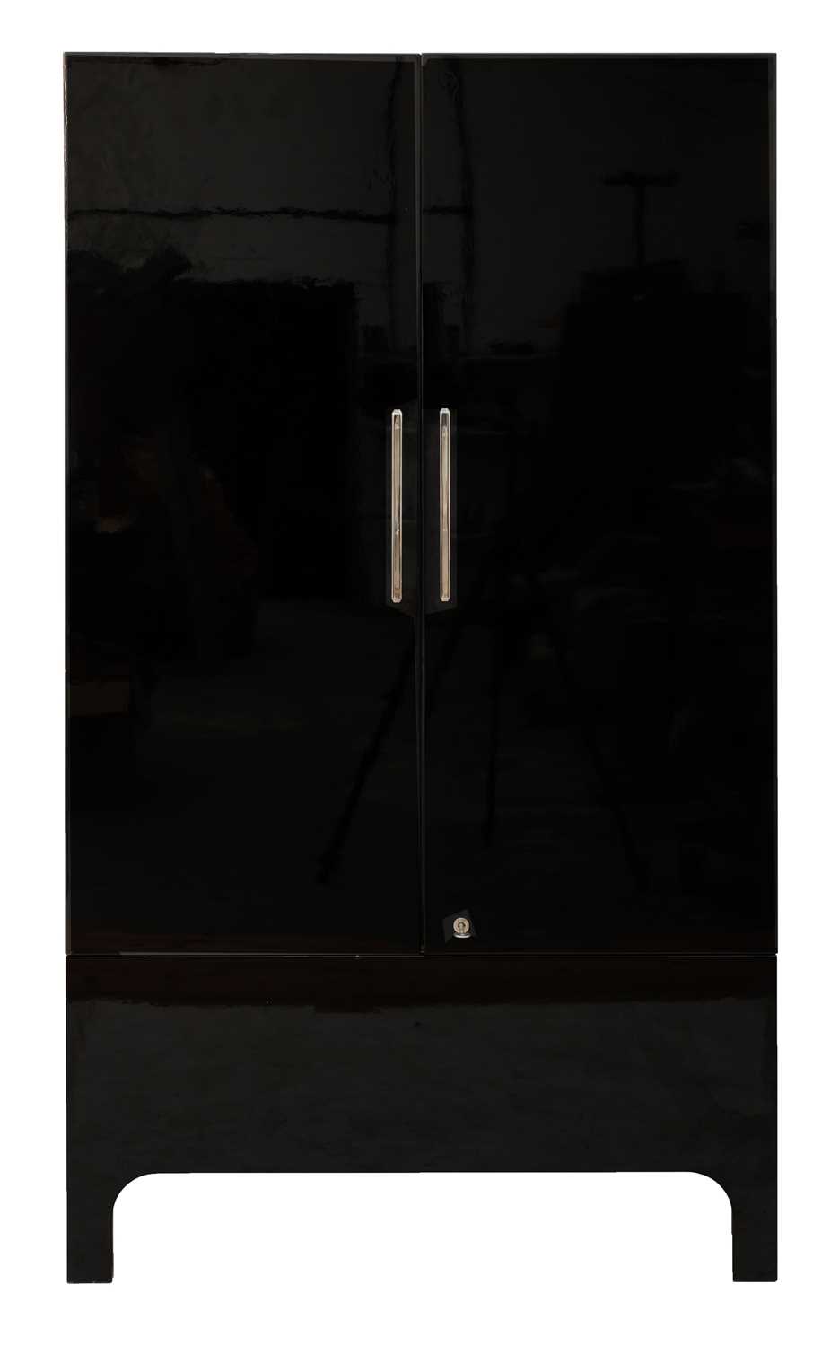 Lot 519 - An ebonised cocktail cabinet