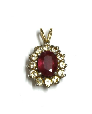 Lot 220 - A gold ruby and diamond cluster pendant