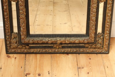 Lot 215 - An ebonised and embossed brass wall mirror