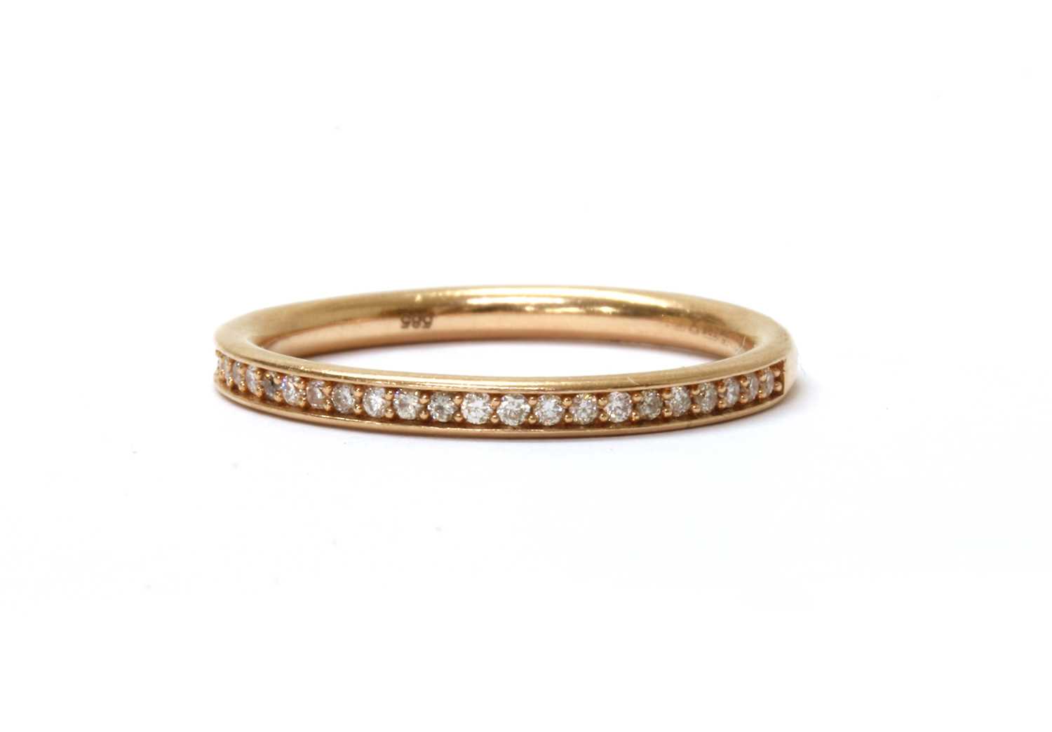 Lot 59 - A 14ct rose gold diamond half eternity ring