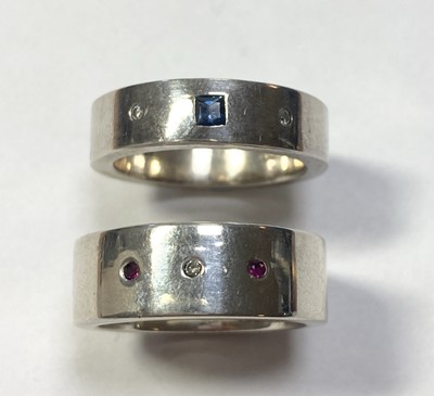 Lot 248 - A silver diamond and ruby set band ring