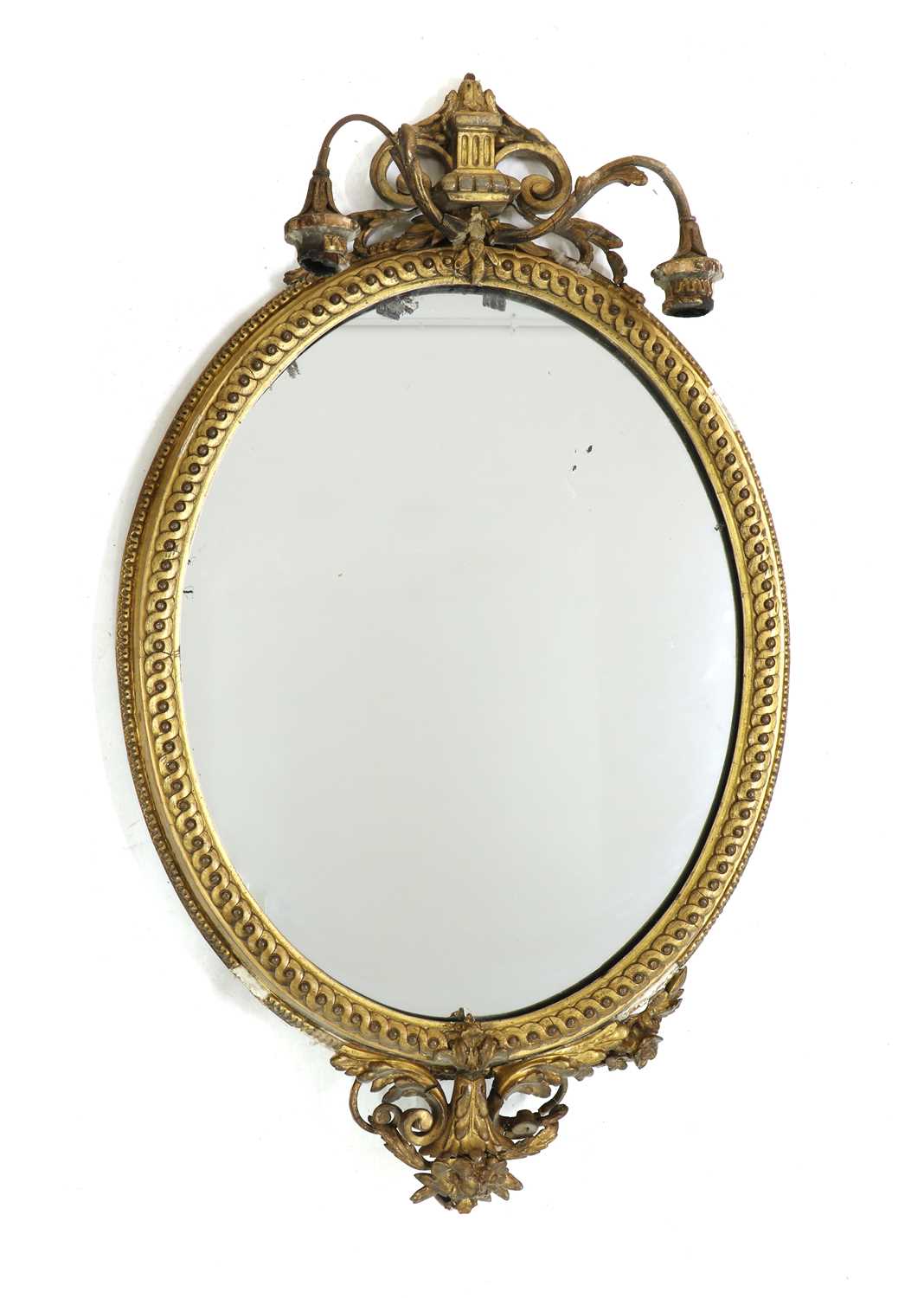 Lot 254 - An Edwardian Neo-Classical style oval giltwood wall mirror