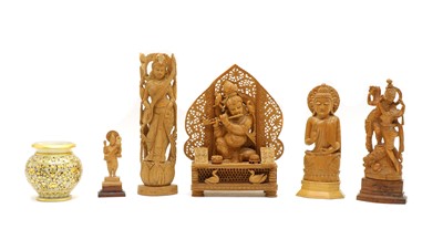 Lot 285 - An Indian carved sandalwood group of a woman playing the flute