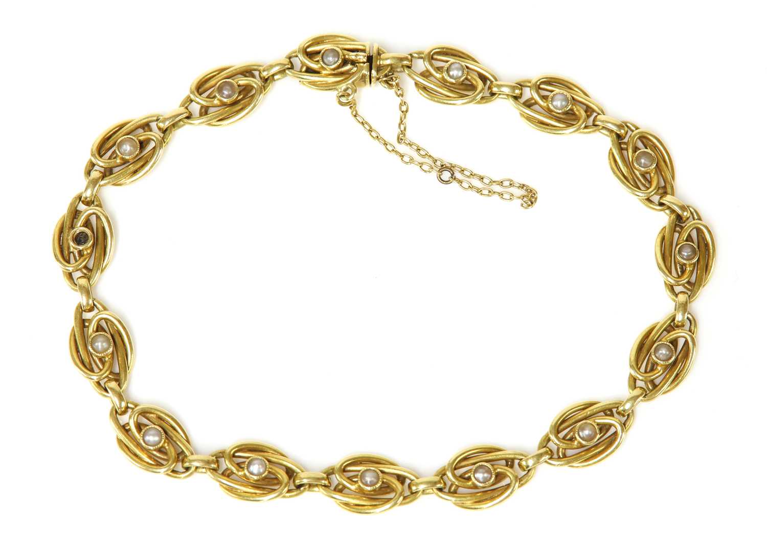 Lot 113 - A Continental gold split pearl bracelet, c.1910