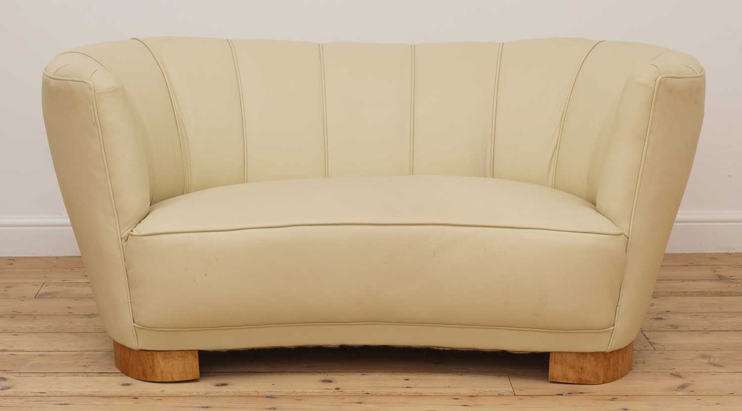 Lot 243 - An Art Deco cream leather settee