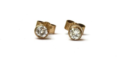Lot 47 - A pair of gold single stone diamond earrings