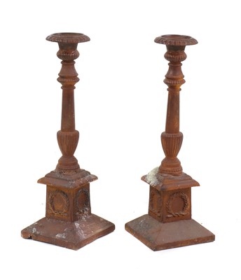 Lot 227 - A pair of cast iron candlesticks