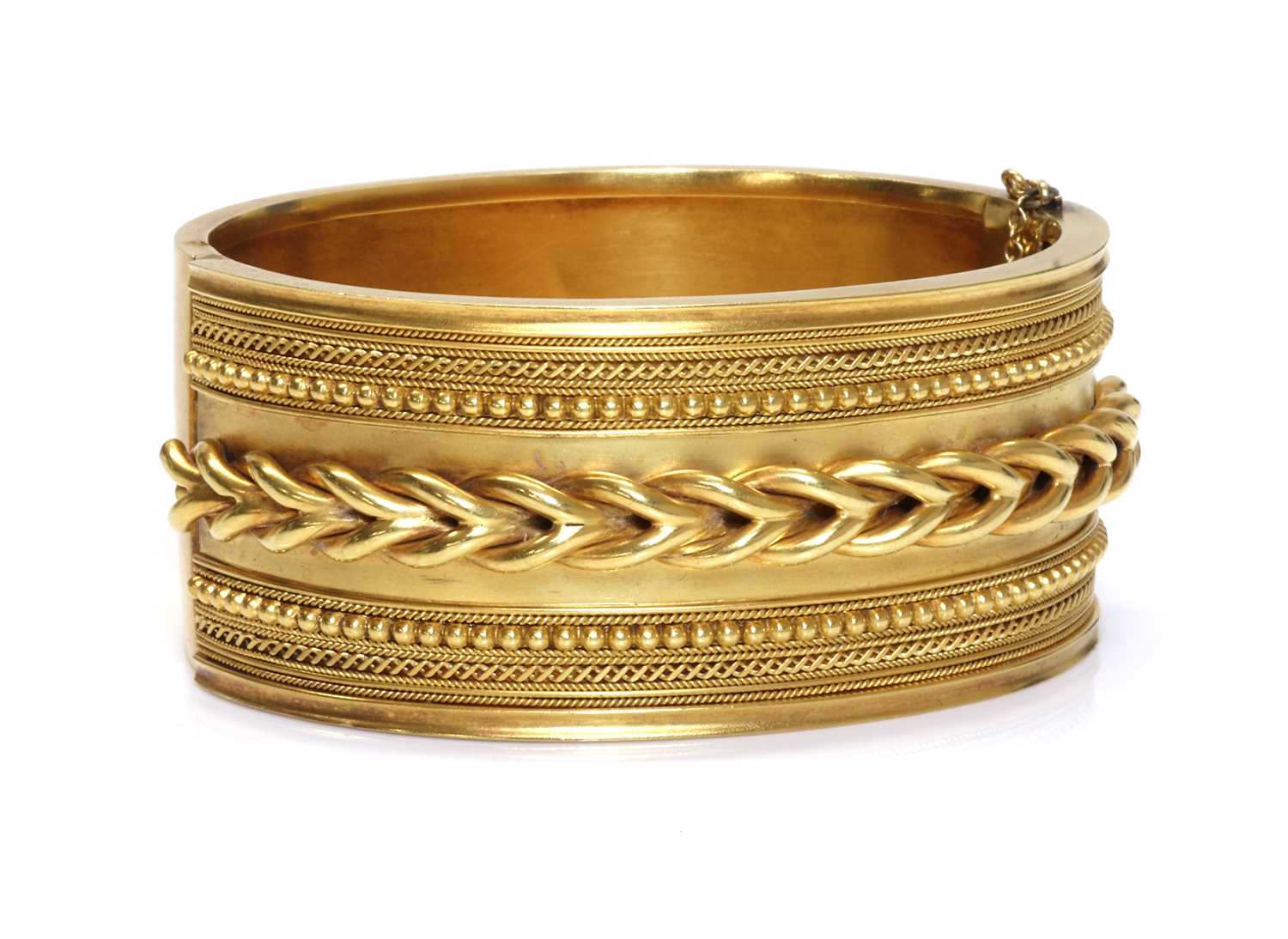 Lot 55 - A cased Victorian gold archaeological revival, Etruscan style hinged bangle, c.1860