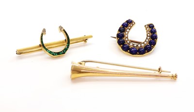 Lot 138 - An emerald and diamond horseshoe bar brooch
