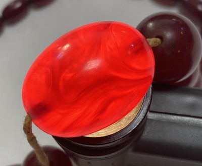 Lot 67 - A single row graduated cherry coloured Bakelite bead necklace