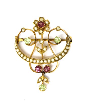 Lot 1047 - An Edwardian gold tourmaline, peridot and split pearl brooch/pendant