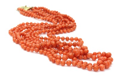 Lot 69 - A four row graduated carved coral bead necklace