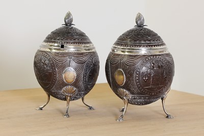 Lot 644 - A pair of George III silver-mounted coconut tureens and covers