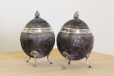 Lot 644 - A pair of George III silver-mounted coconut tureens and covers