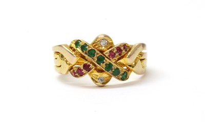 Lot 135 - A gold emerald. ruby and diamond set puzzle ring