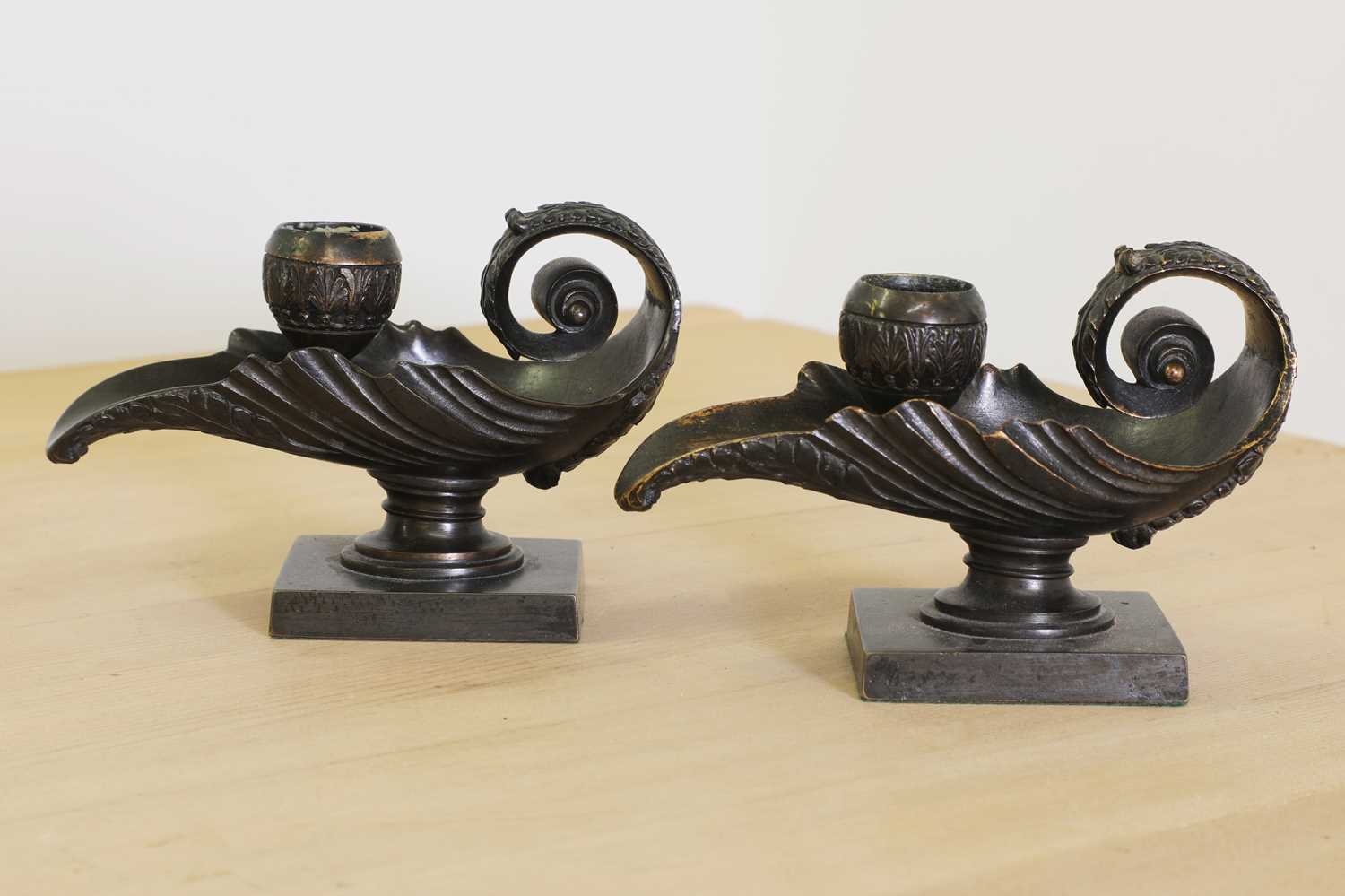 Lot 215 - A pair of grand tour bronze candlesticks