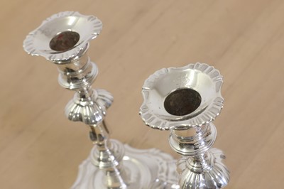 Lot 635 - Two George II cast silver candlesticks