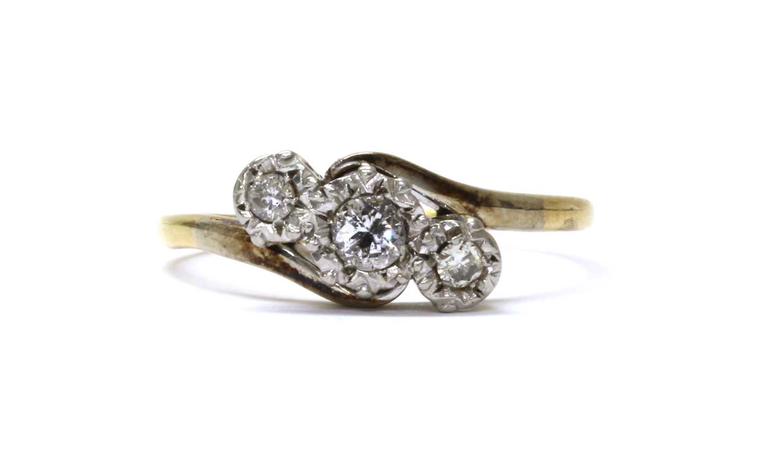 Lot 53 - A gold three stone diamond crossover ring