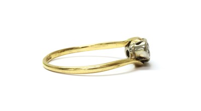 Lot 54 - A gold three stone diamond crossover ring