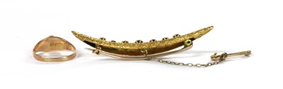 Lot 1015 - A gold sapphire set crescent brooch
