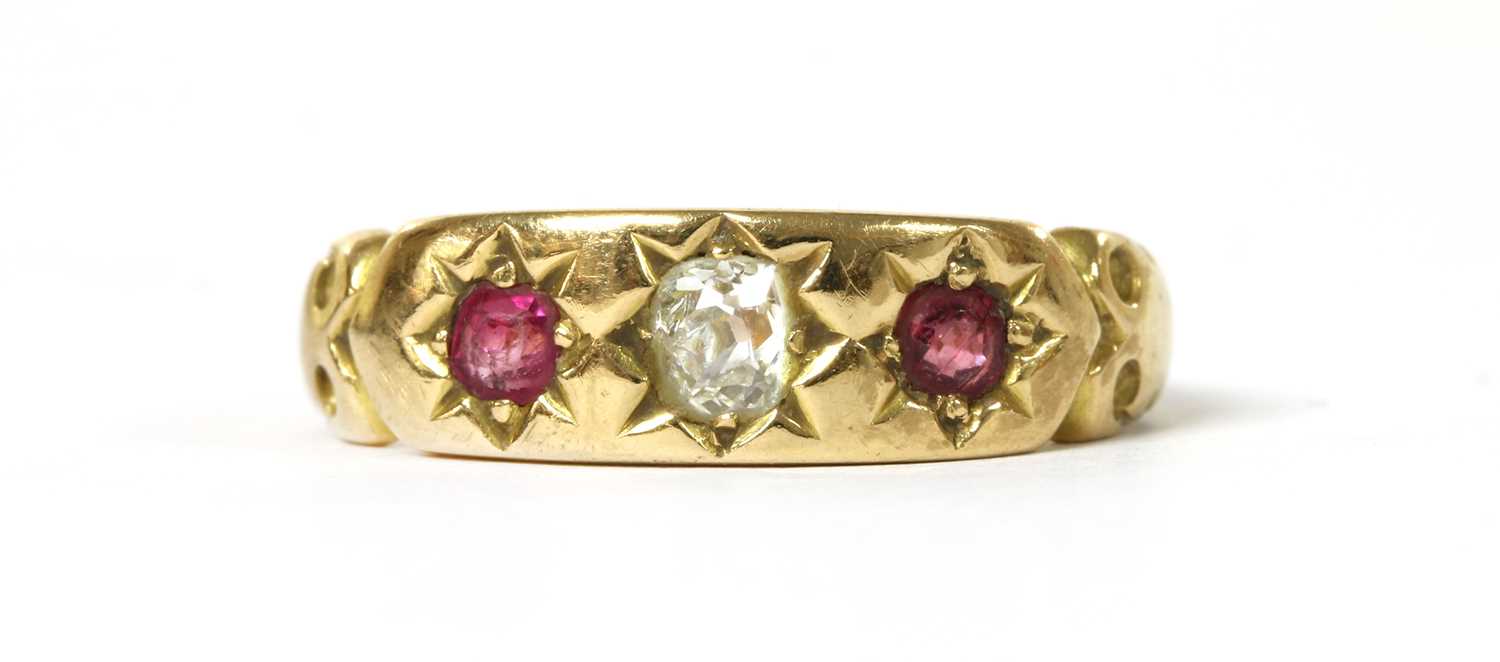Lot 1032 - A gold diamond and ruby three stone ring
