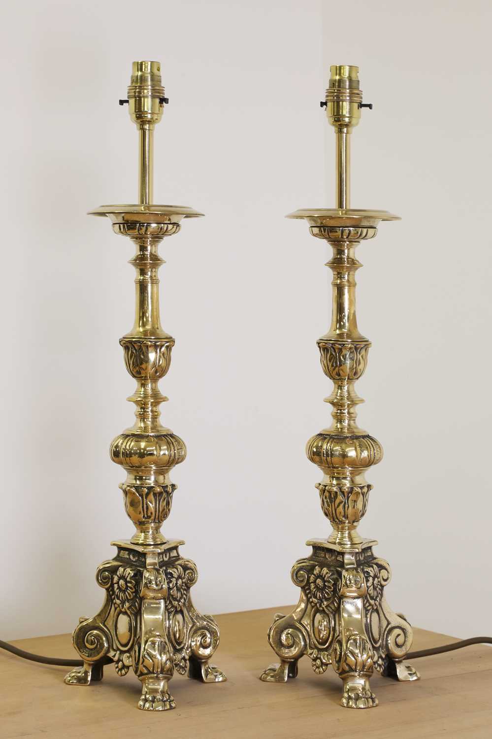 A pair of cast brass altar candlestick lamps Barnebys