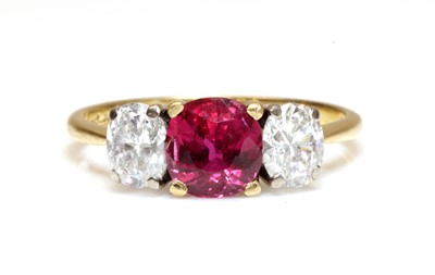 Lot 472 - An 18ct gold three stone fracture filled ruby and diamond ring, by Kutchinsky